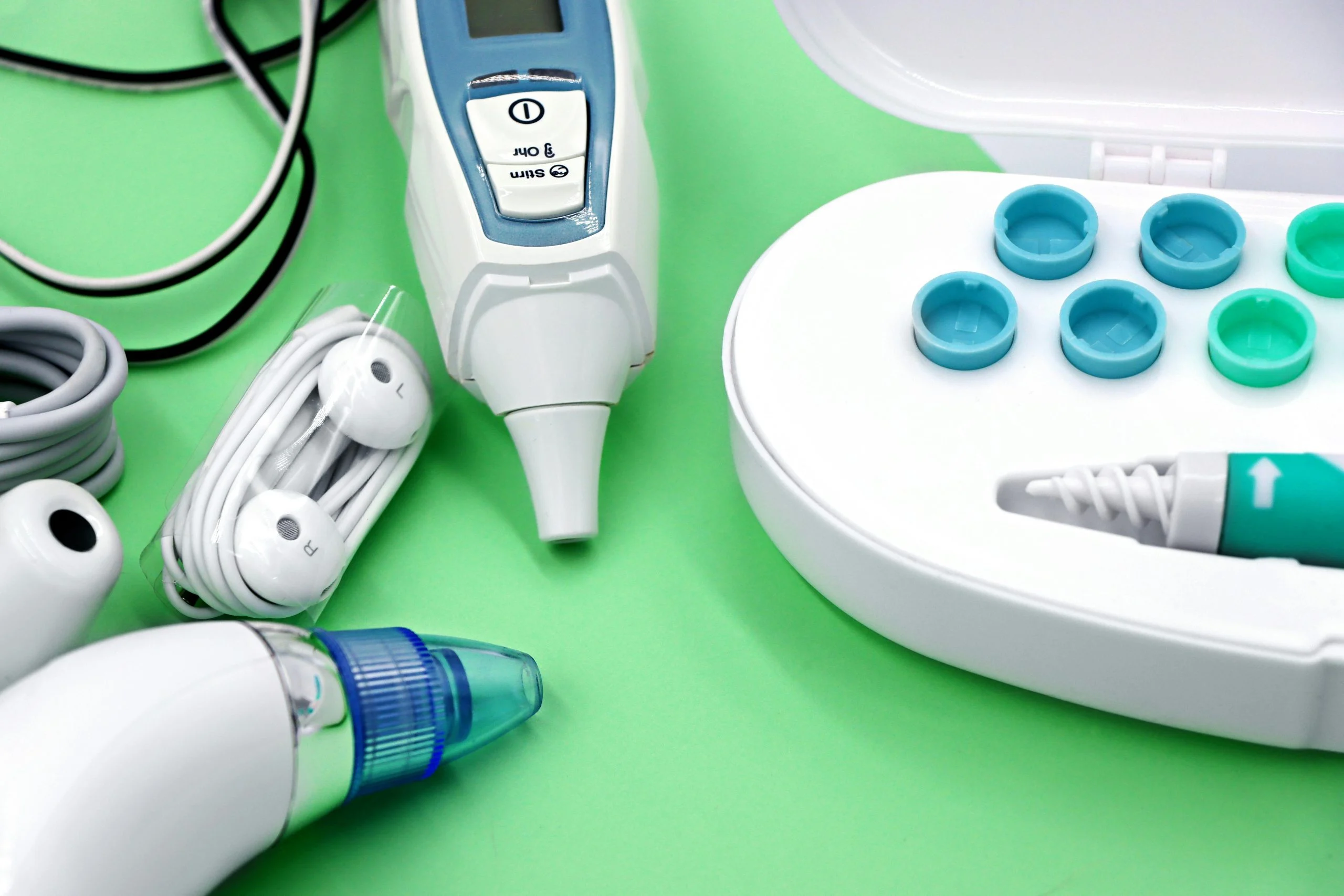 A variety of ear care devices including ear buds, medical instruments, and cleaning tools.
